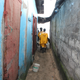 Medical personnel rushes to a house in Monrovia’s West Point community at the beach. Three dead Ebola patients are locked inside.